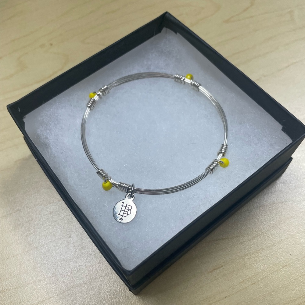Bourbon and Boweties standard size silver bangle with yellow accents